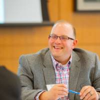GVSU Alumni sitting at a table talking.